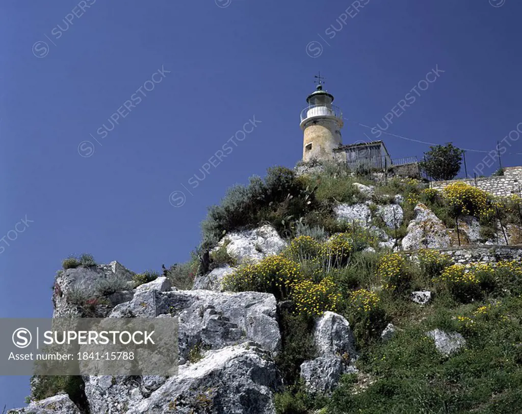 Low angle view of lighthouse on cliff