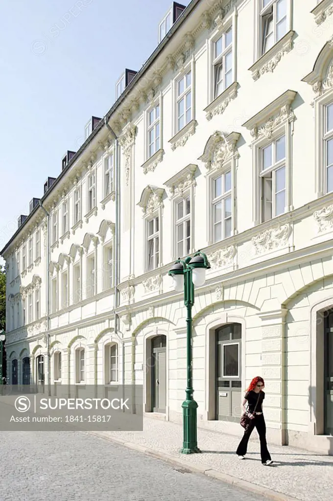 Woman walking on sidewalk, Weimar, Thuringia, Germany