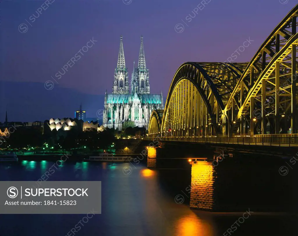 Railroad Bridge across river at dusk, Hohenzollern Bridge, Cologne, Germany