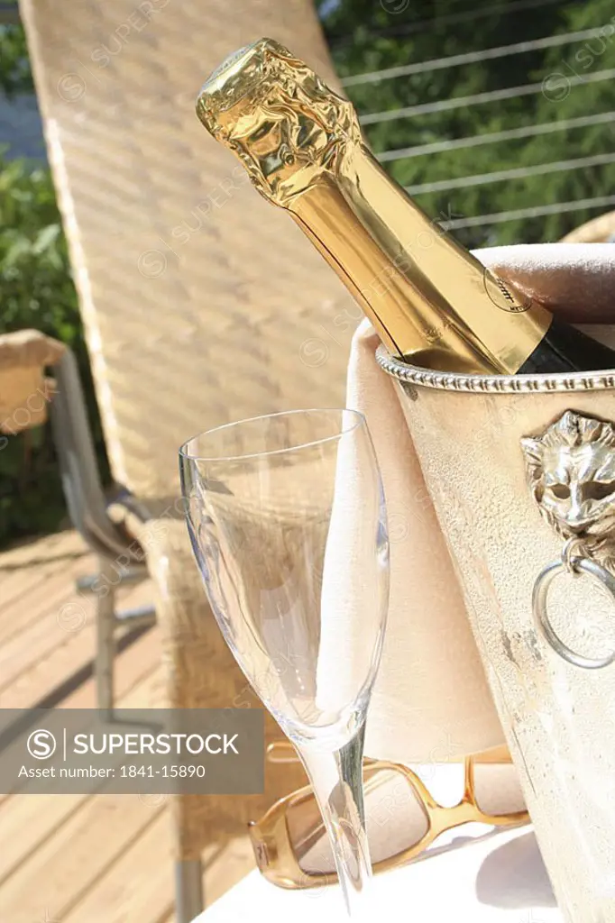 Close_up of champagne bottle in a champagne bucket on table