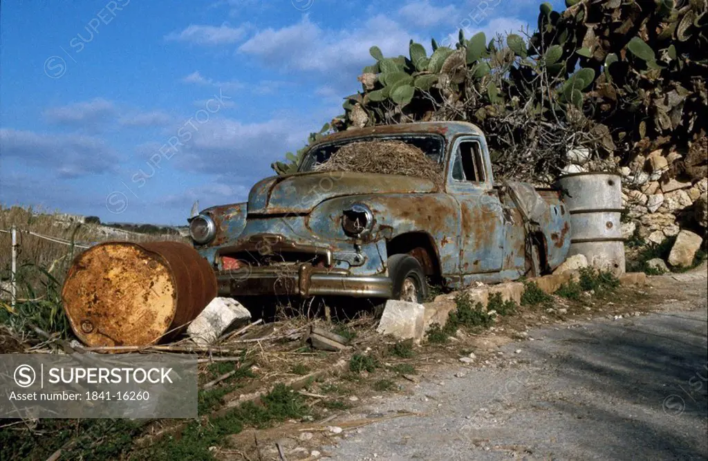 Wrecked car at roadside, Malta