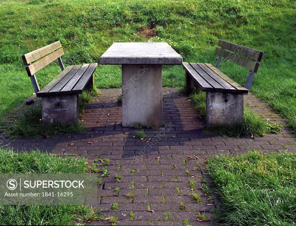 Empty picnic table on grassy landscape