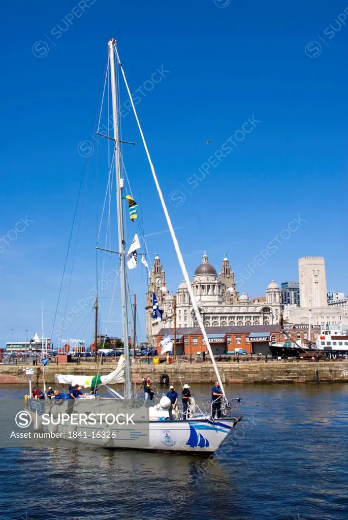 Boat in river with buildings in background, Cunard Building, Royal Liver Building, Port Of Liverpool Building, River Mersey, Liverpool, Merseyside, No...