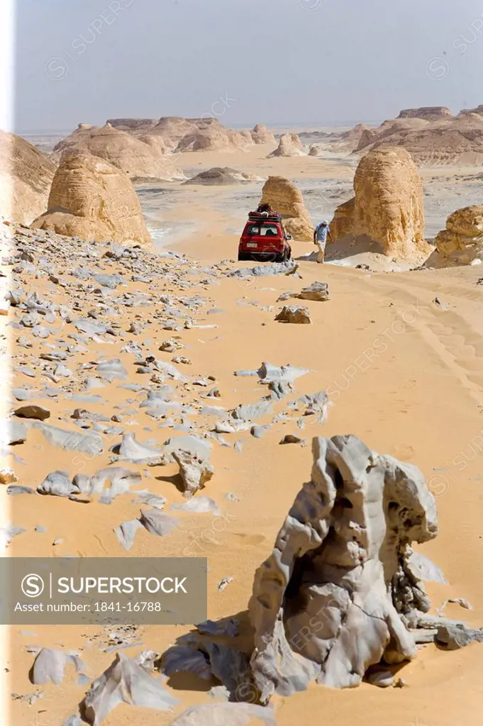 Car in arid landscape, Farafra Oasis, Libyan Desert, Egypt
