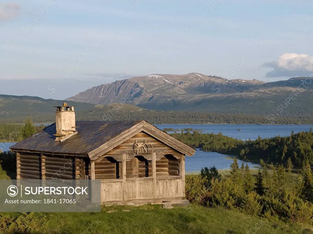 Wooden house at lakeside, Rondane National Park, Fjell, Hordaland County, Norway