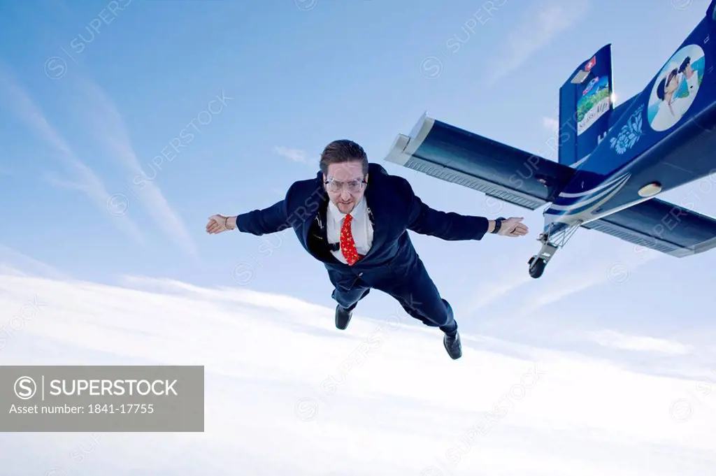 Businessman jumping out of propeller plane, Switzerland