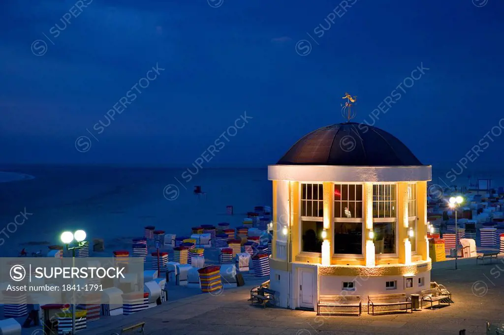 Pavilion and hooded beach chairs on beach at night, Borkum, Lower Saxony, Germany