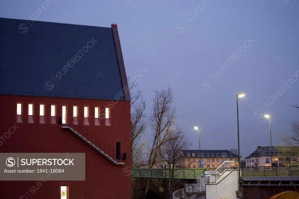 Lamp posts in front of building lit up at dusk, Alte Bruecke, Frankfurt, Germany