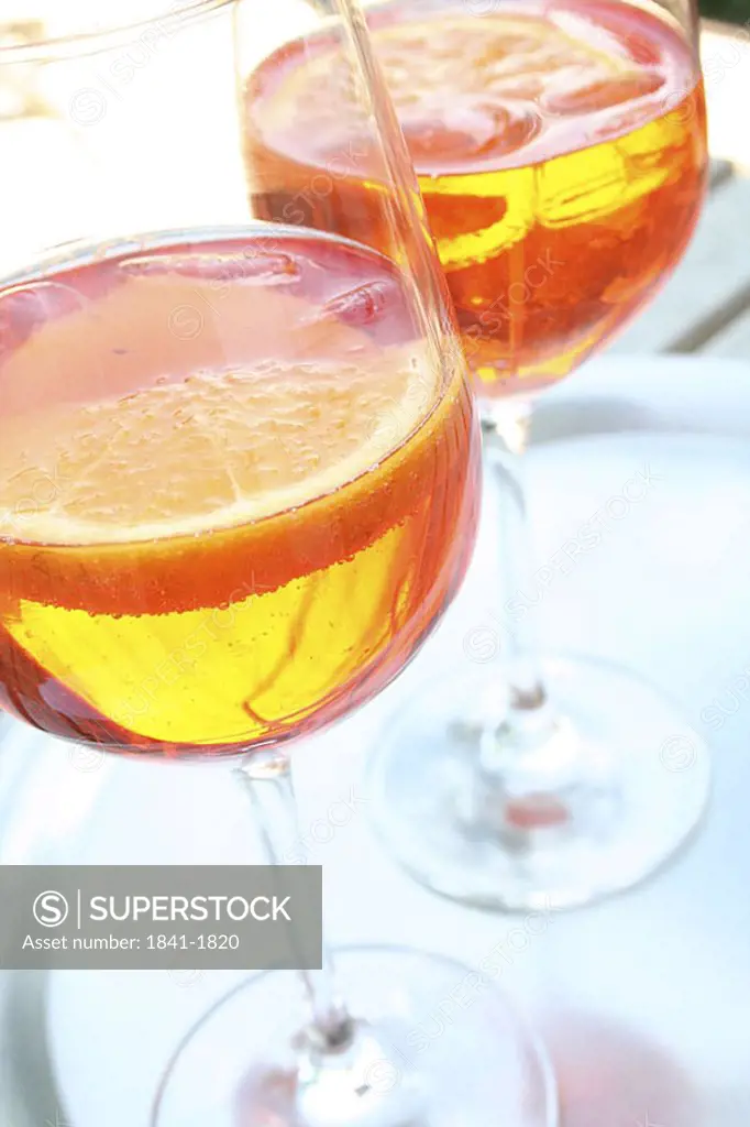 Close_up of two glasses of cocktails and slices of orange