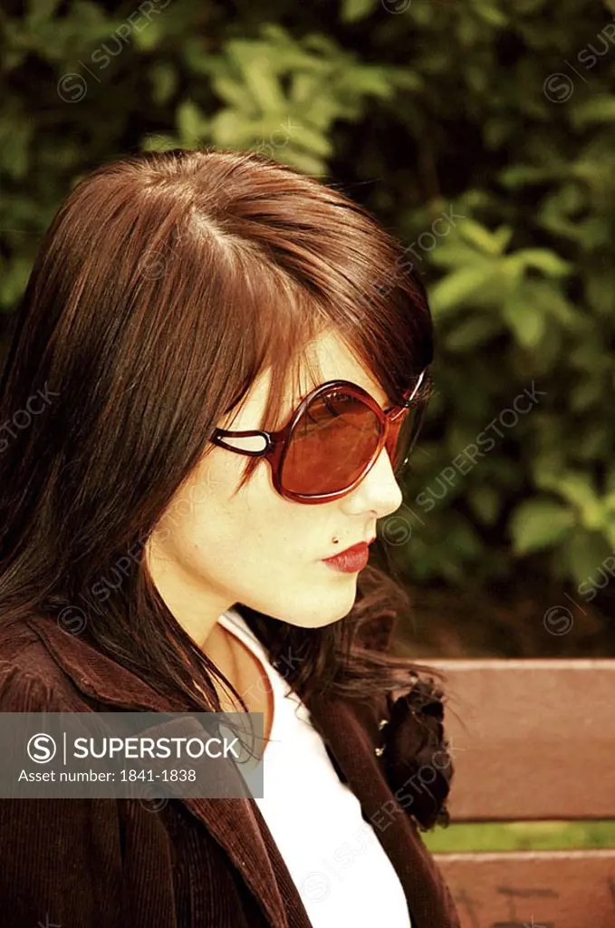 Close_up of young woman wearing sunglasses