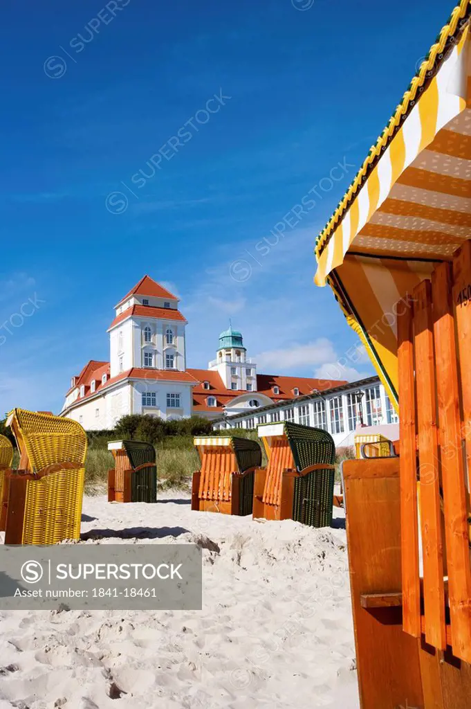 Hooded Beach Chairs on the beach of Binz, spa hotel in the background, Ruegen, Germany