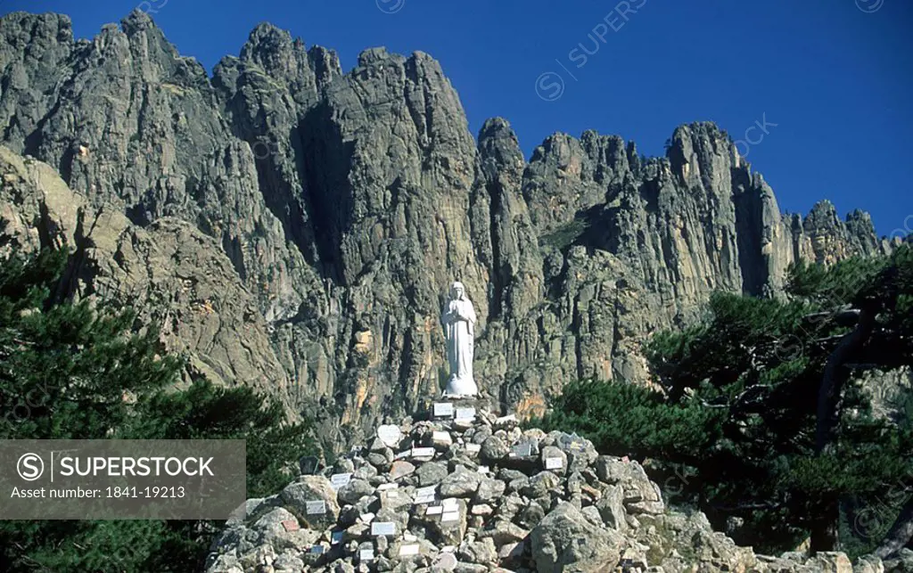 Statue on top of pile of rocks, Bavella, Corsica, France