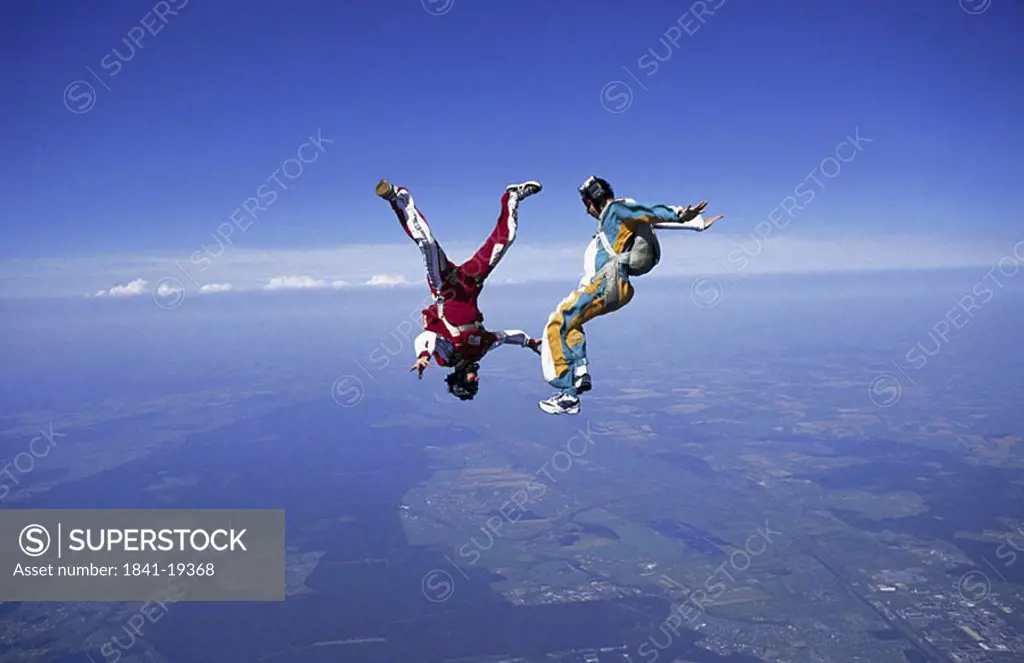 Two people parachuting mid air