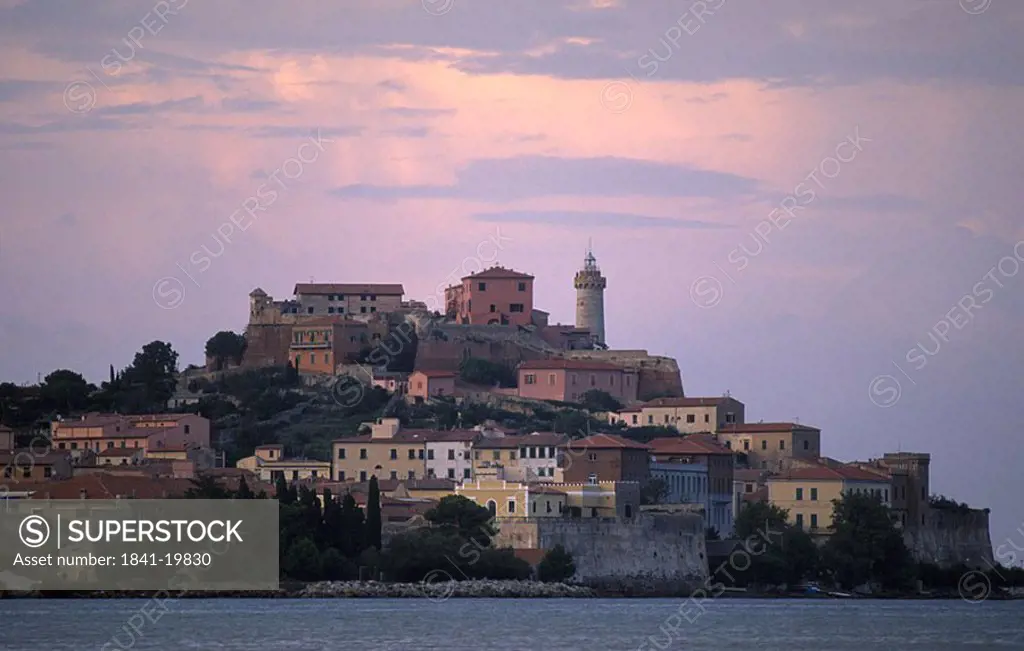 Town on hill against dusky sky, Isle Of Elba, Italy