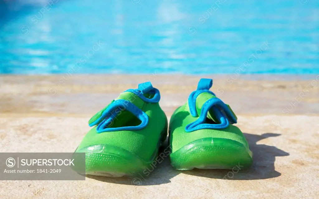 Bathing shoes by pool side, close_up