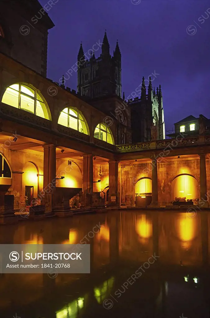 Lit up roman bath at night, England