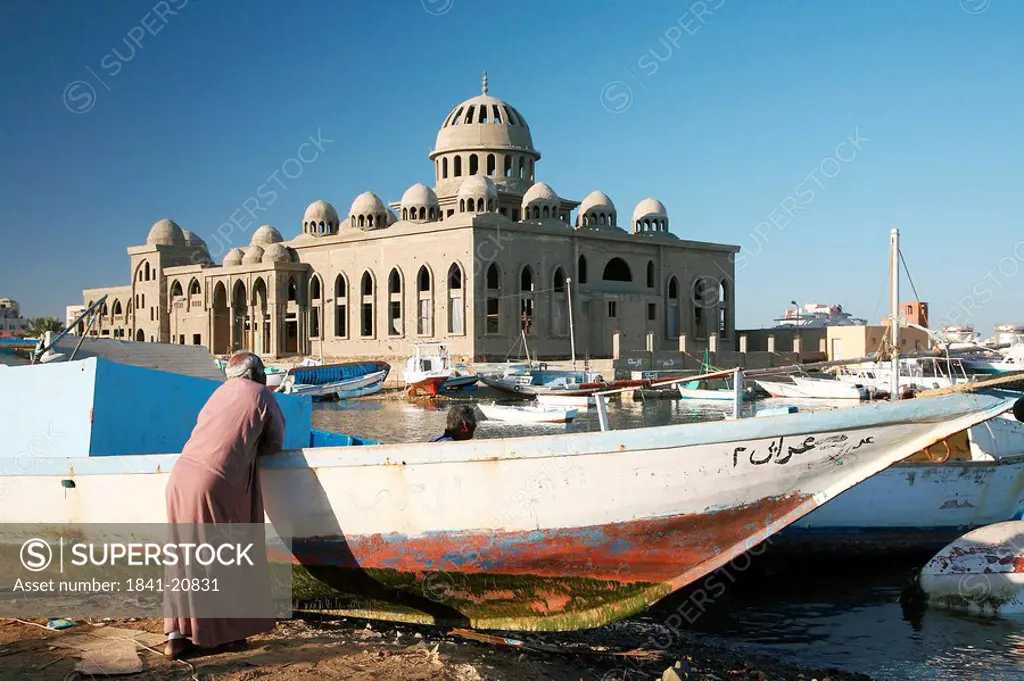 Men at a fishing harbour, mosque in the background, Hurghada, Egypt