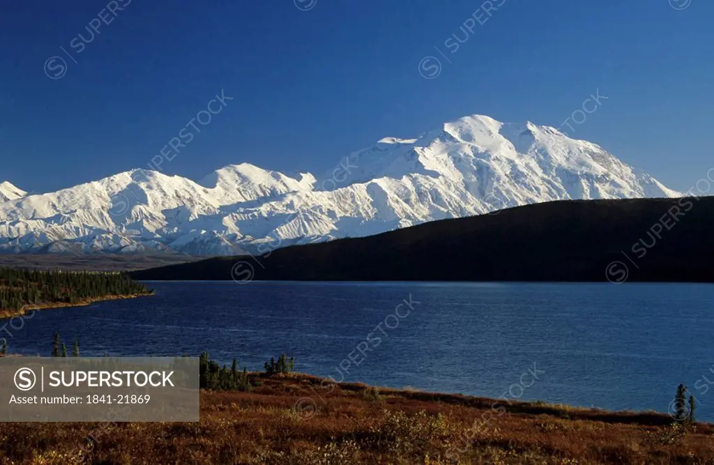 Lake in front of snow covered mountain range, Mt McKinley, Wonder Lake, Denali National Park, Alaska, USA
