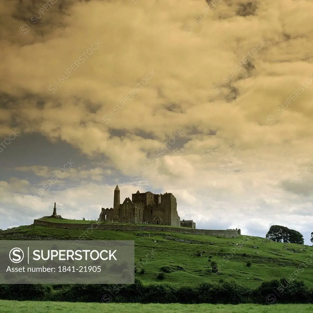 Low angle view of palace on hill under cloudy sky, Rock Of Cashel, Republic of Ireland