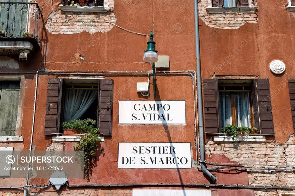Street signs on a house facade, Venice, Italy, low angle view