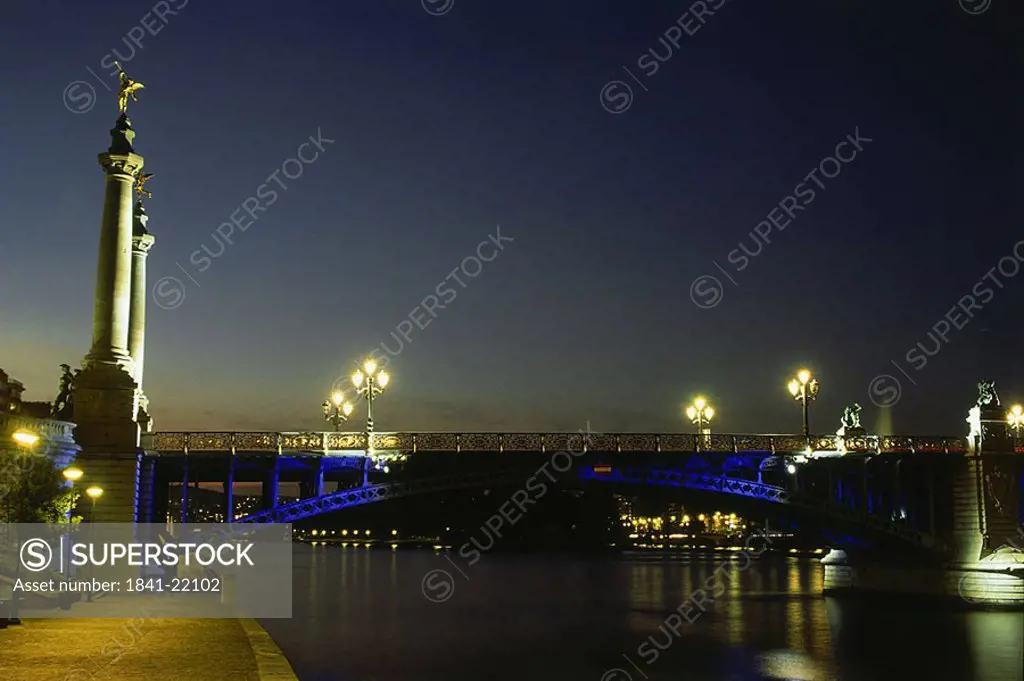 Bridge across river lit up at night, Belgium