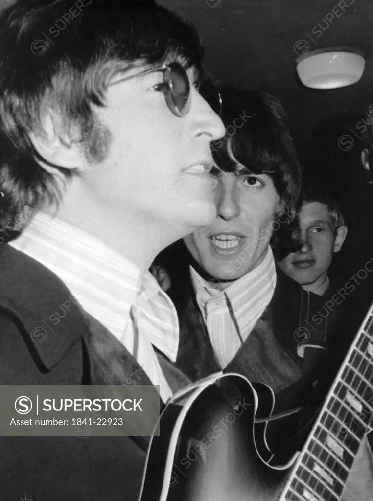 John Lennon and George Harrisson at concert