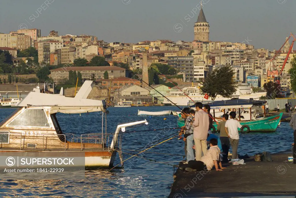 Group of people fishing in straits, Bosphorus, Istanbul, Turkey