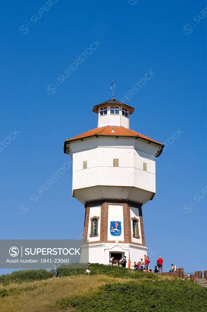 Tourists near lighthouse, Langeoog, Lower Saxony, Germany
