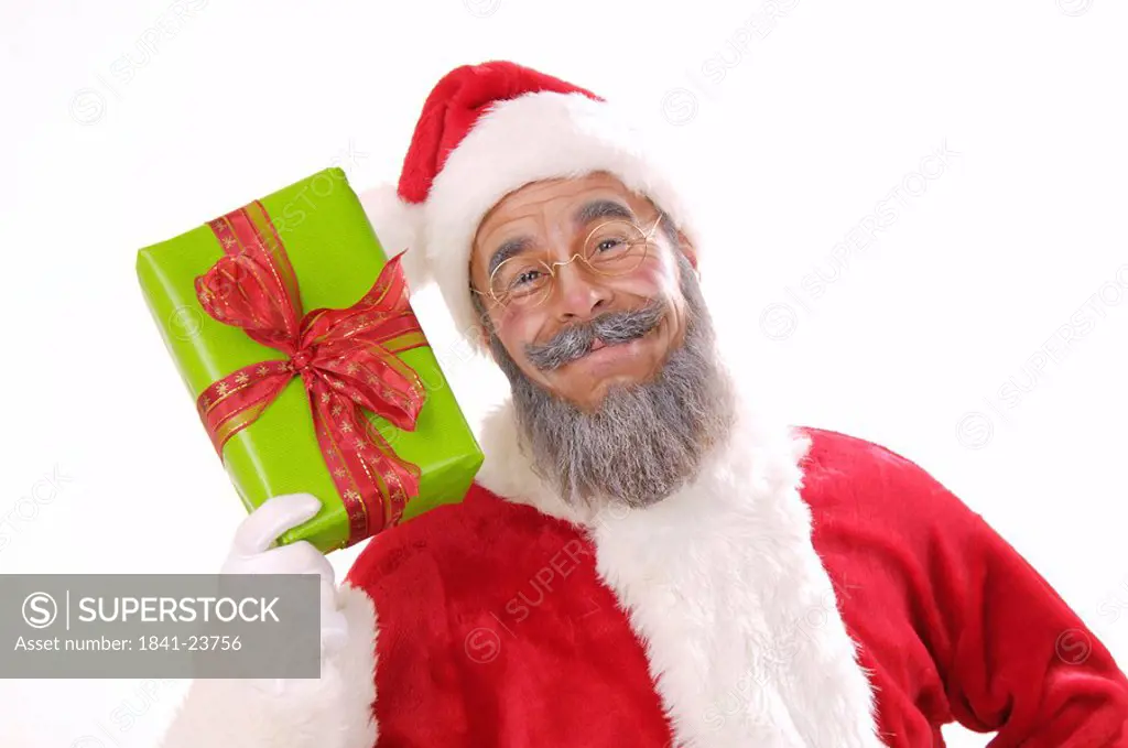 Portrait of senior man in santa costume showing Christmas gift
