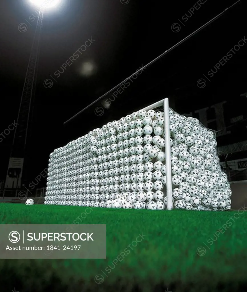 Goal full of soccer balls in stadium