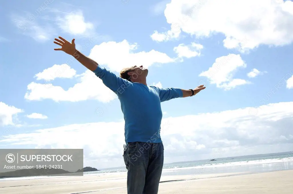 Man stretching his arms on the beach
