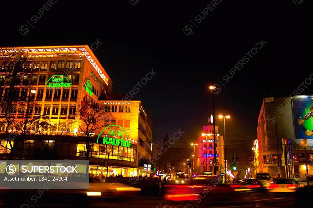 Buildings lit up at night in city, Munich, Bavaria, Germany