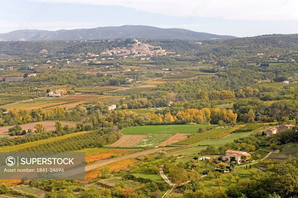 High angle view of fields with village in background, Lacoste, Luberon, Vaucluse, Provence_Alpes_Cote d´Azur, France