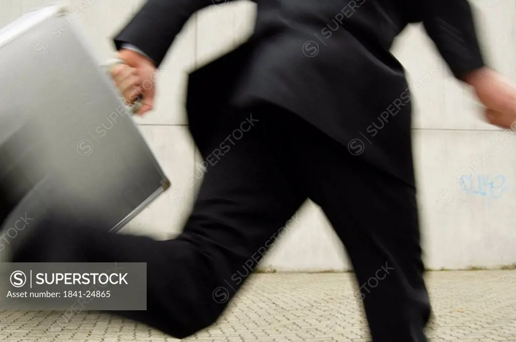 Low section view of businessman running