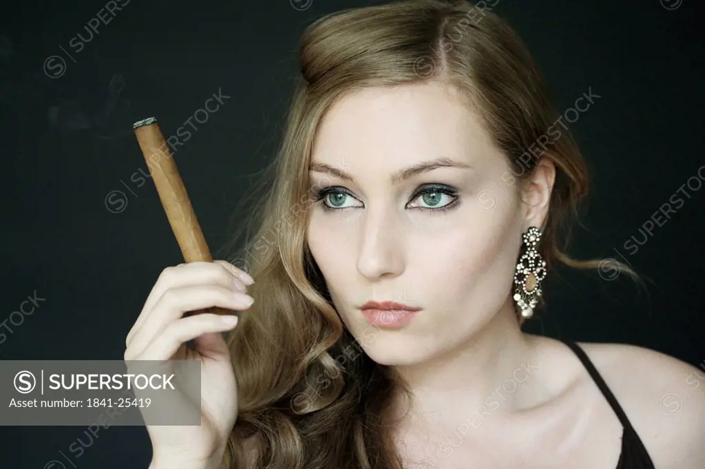 Young woman holding cigar
