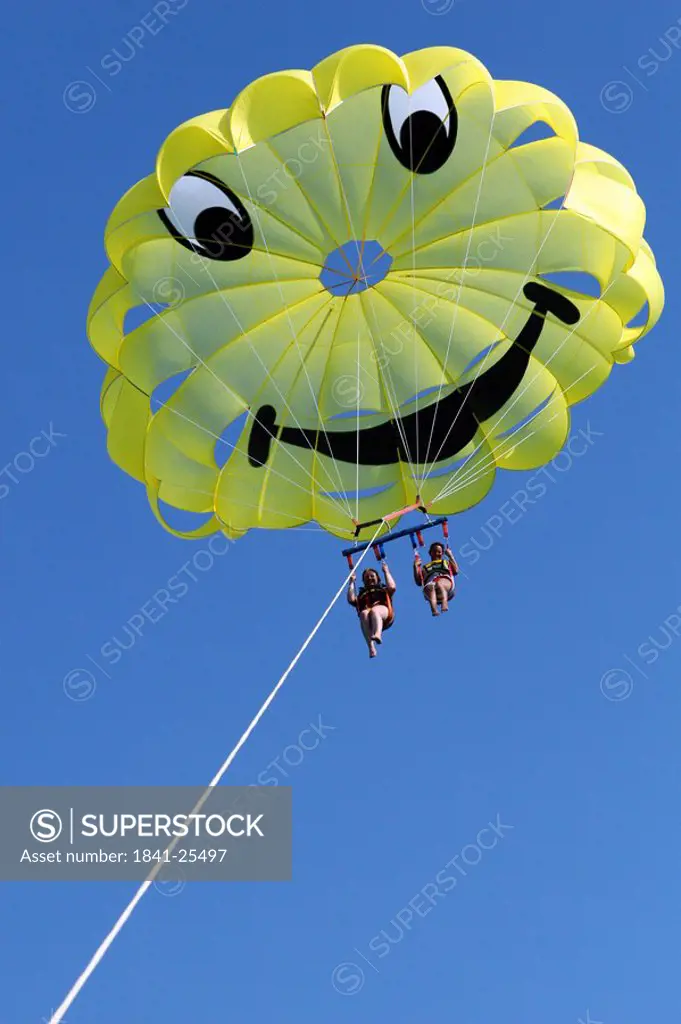 Low angle view of tourists parasailing, Peloponnese, Greece