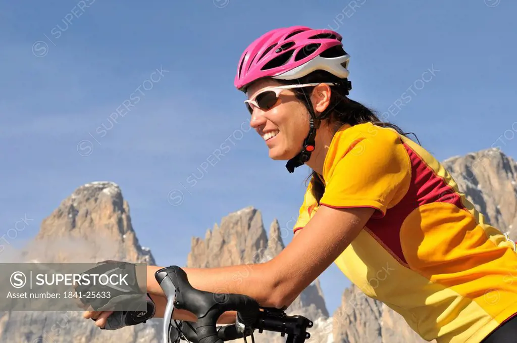 Close_up of female mountain biker smiling, Dolomites, Italy