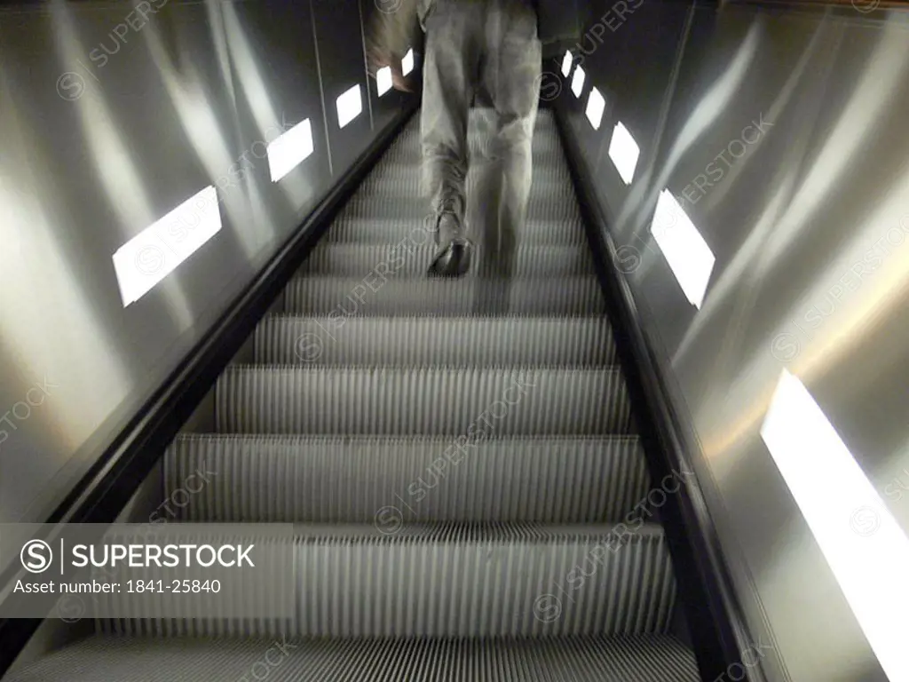 Low angle view of man on escalator