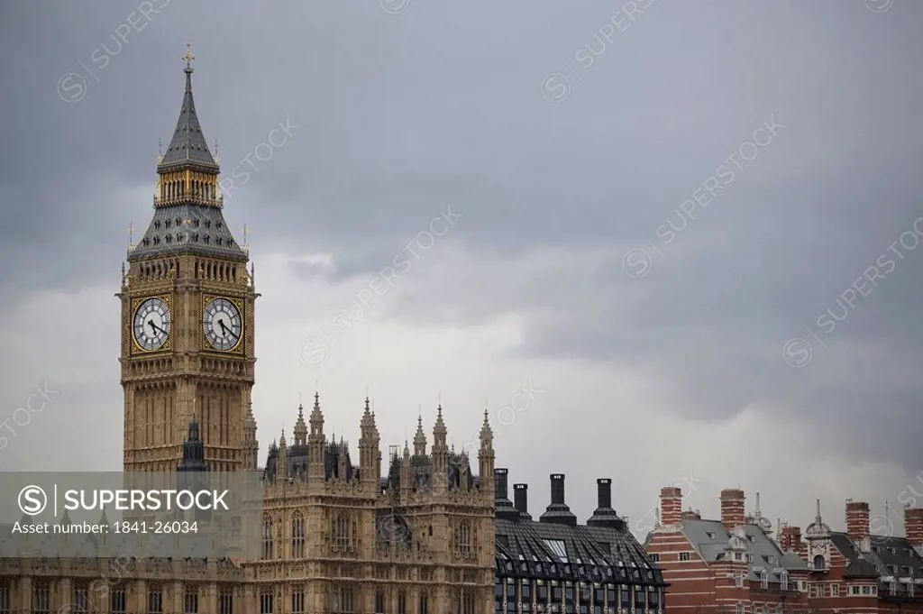 Clock tower and building against overcast sky, Westminster, Big Ben, London, England