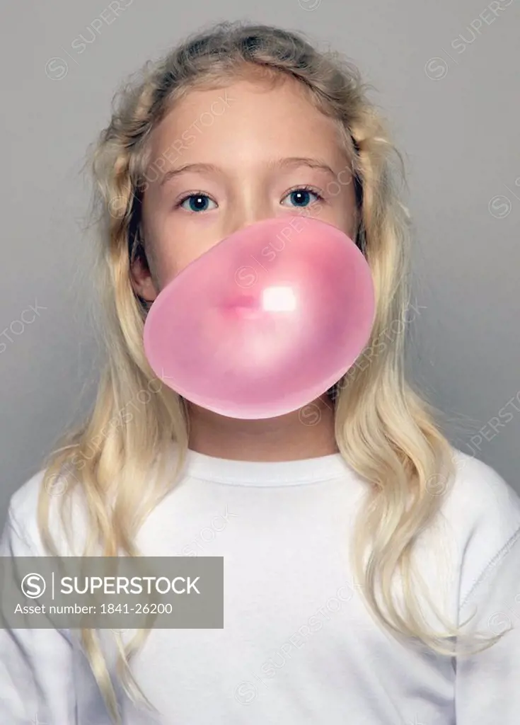 Portrait of girl blowing chewing gum