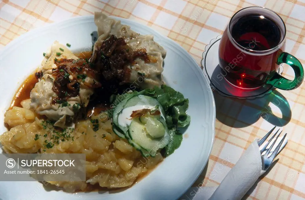 High angle view of a plate of swabian pasta with red wine, Germany, Europe