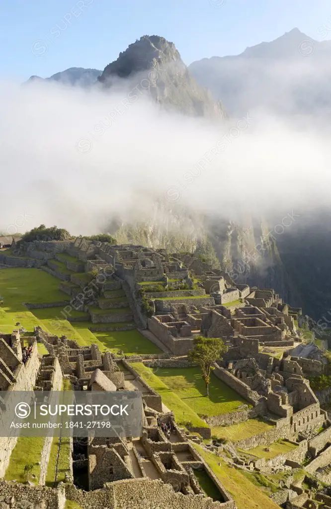 Clouds over old ruins on mountain, Inca Ruins, Machu Picchu, Cusco Region, Peru