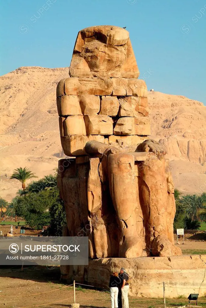 Tourists in front of a Colossus of Memnon, Luxor, Egypt