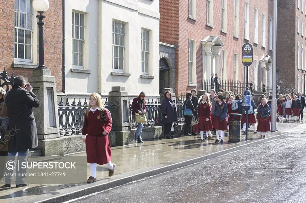 School children walking on roadside, Dublin, Republic of Ireland