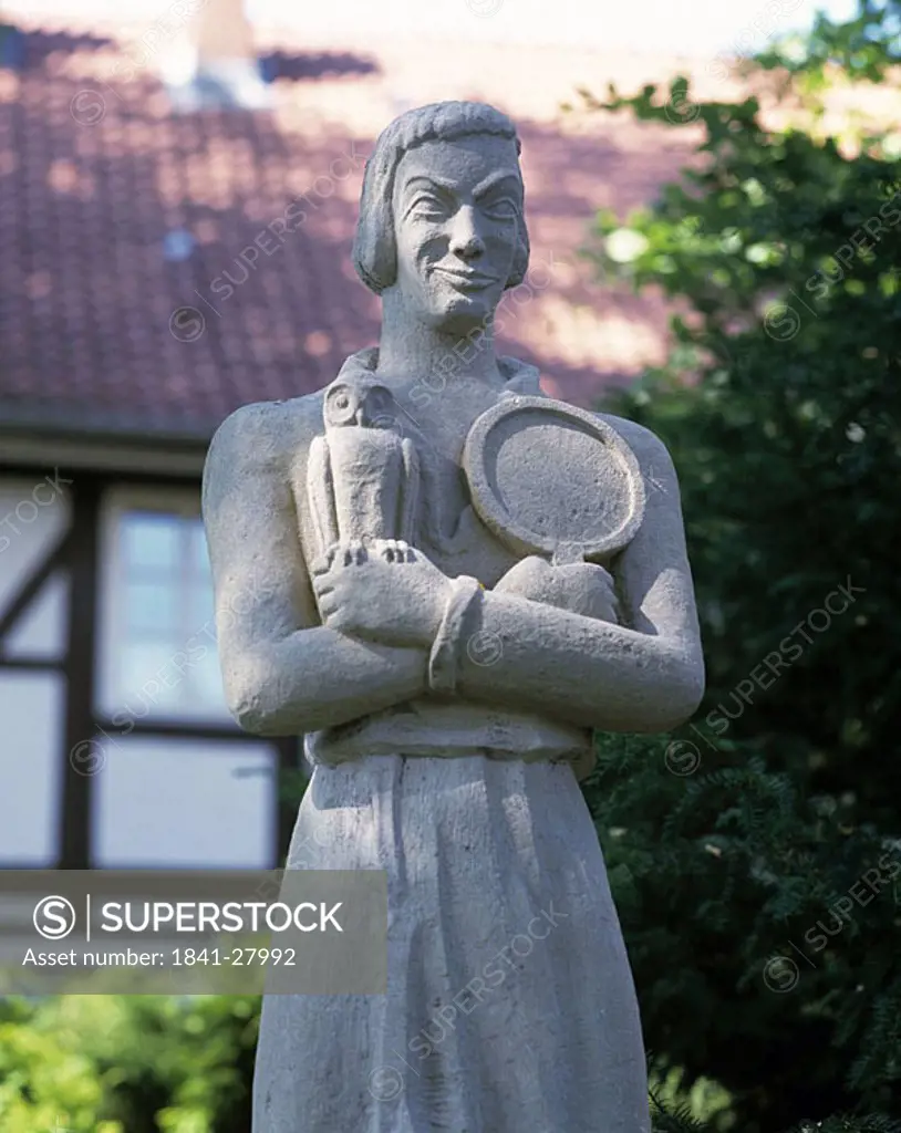 Statue in front of building, Till Eulenspiegel Monument, Wolfenbuettel, Lower Saxony, Germany