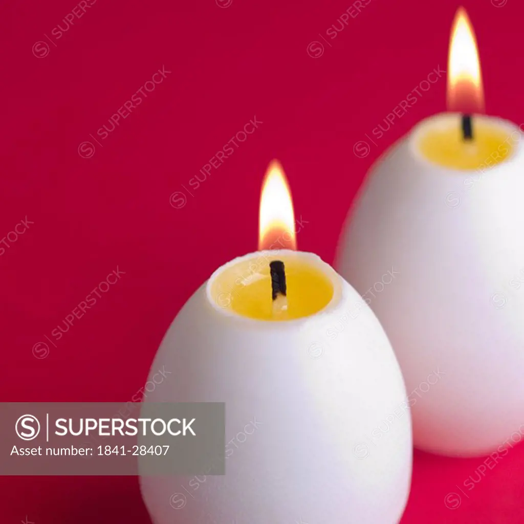 Close_up of lit egg shaped candles