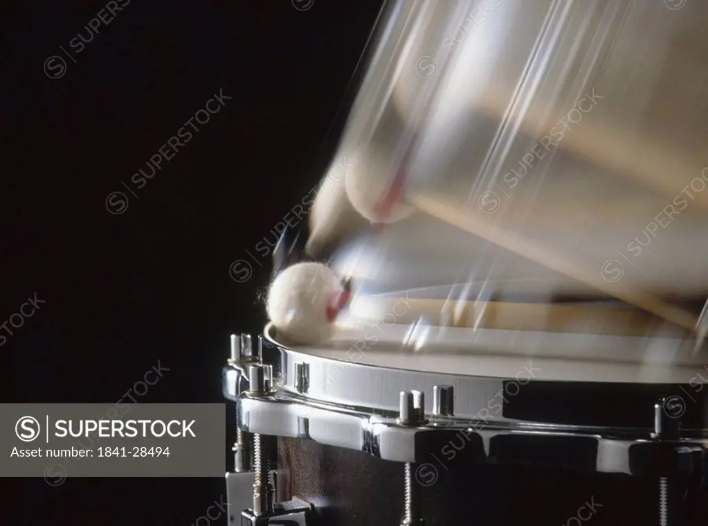 Close_up of drumstick and snare drum