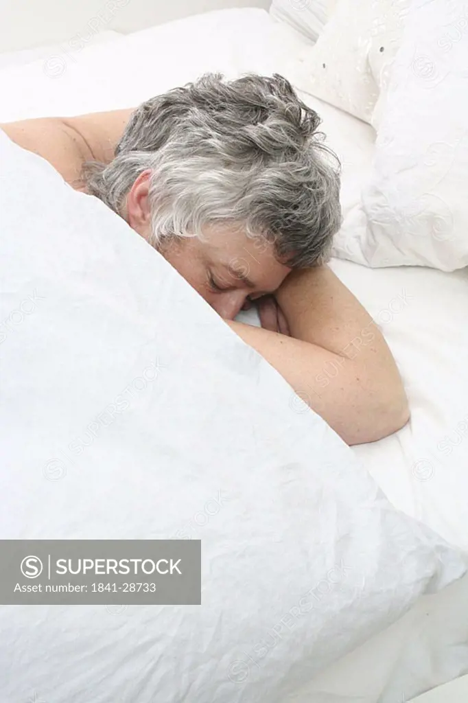 High angle view of senior woman sleeping in bed