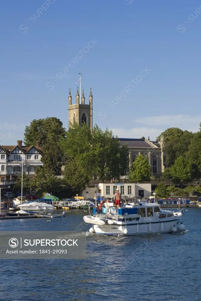 Tourboat in river with church in background, Thames River, Hampton Church, Hampton, London, England