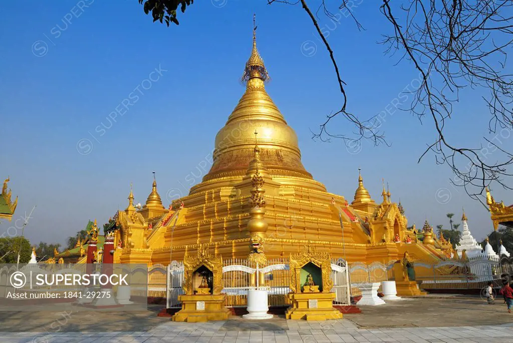 Golden pagoda at Buddhist temple under clear blue sky, Kuthodaw Pagoda, Mandalay, Myanmar
